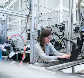 woman working at a machine station 